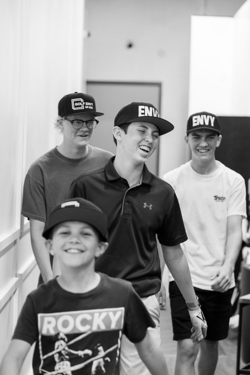 Group of junior golfers laughing together at Golf Envy
